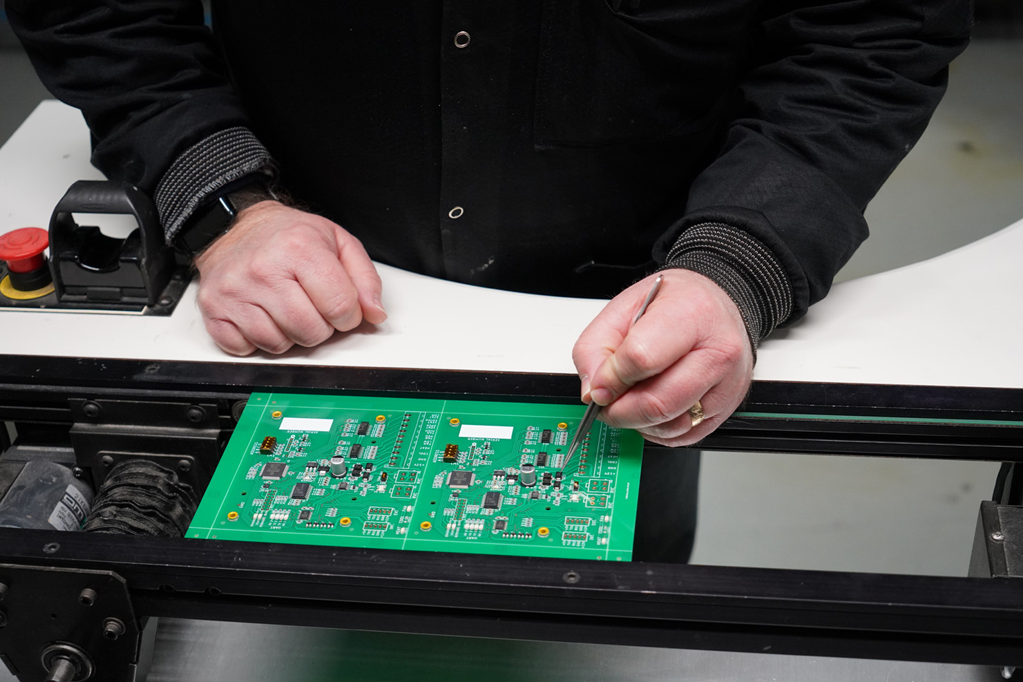 Man reviewing PCB board components after SMT placement