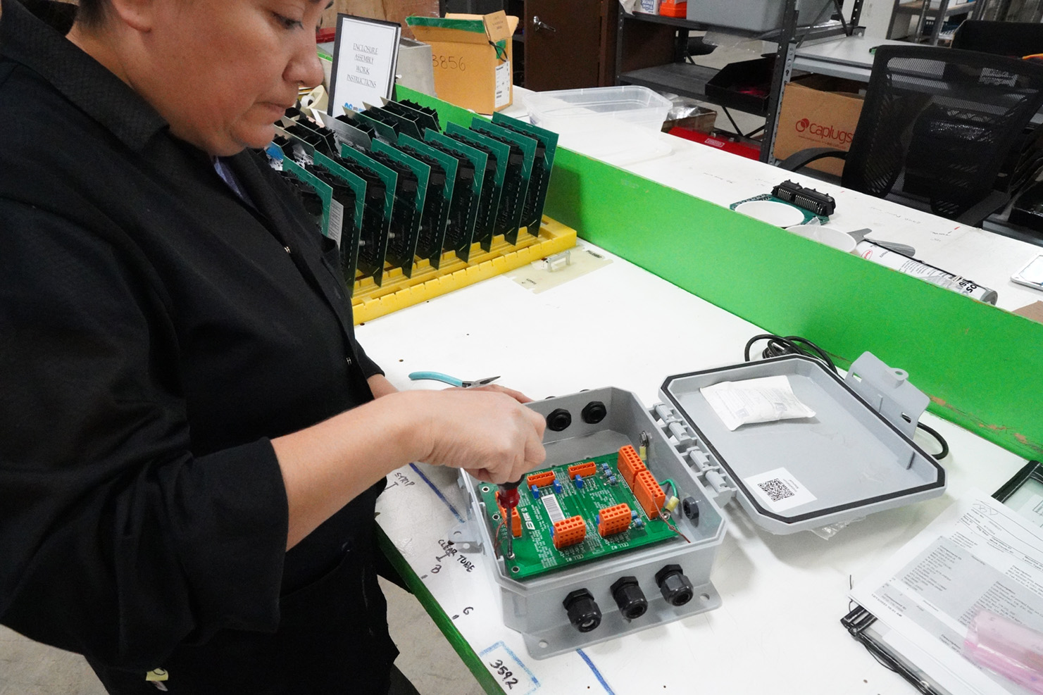 Woman installs PCB Board in Box