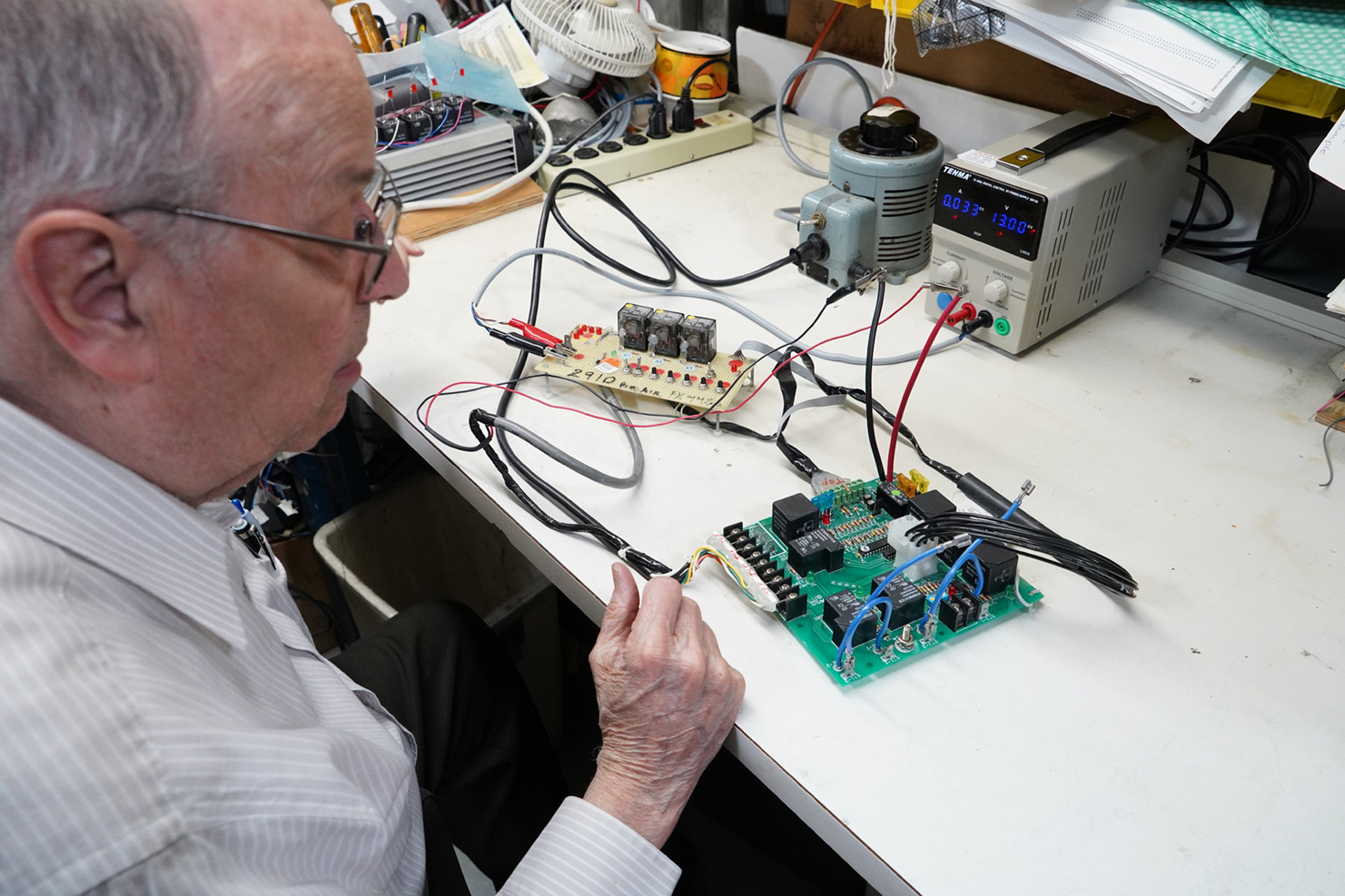 Man testing PCB board for electrical output